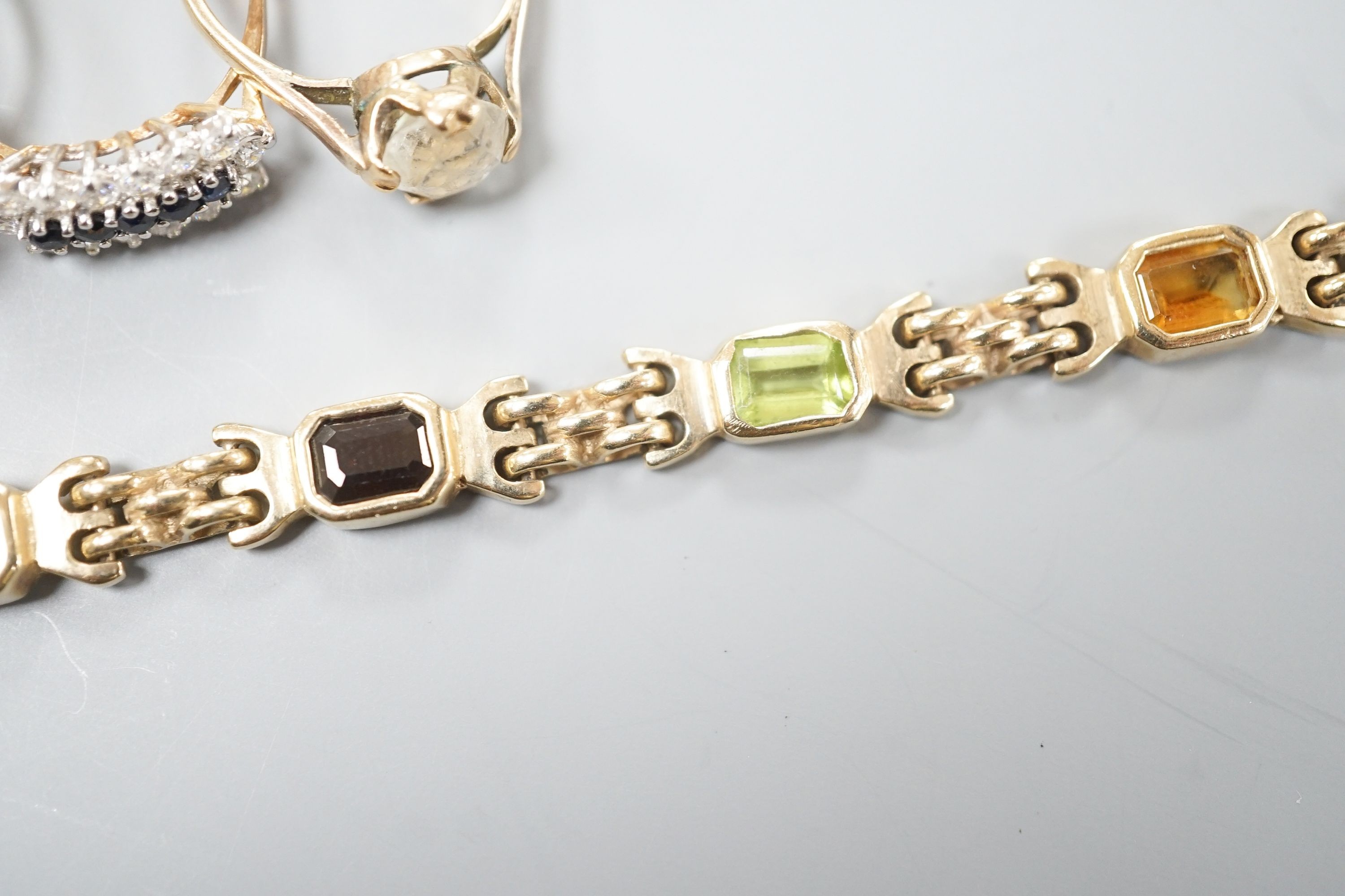 A modern 9ct gold and gem set bracelet and four assorted 9ct gold dress rings, gross 24.8 grams